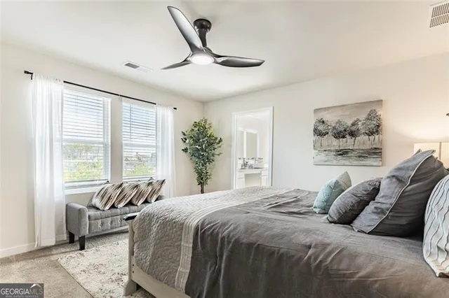 a bedroom with a large bed and a window