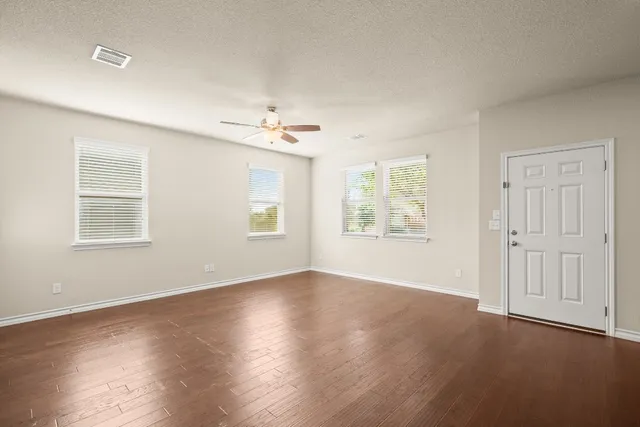 a kitchen with stainless steel appliances granite countertop a sink a stove and a wooden floors