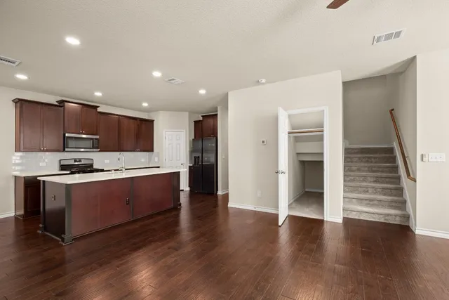 a view of kitchen with sink and wooden floor