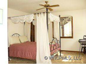 764 Oscar Chappell Road Brevard, NC 28712 - Photo 11 of 21 a bedroom with a bed and a window
