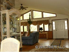 764 Oscar Chappell Road Brevard, NC 28712 - Photo 16 of 21 a living room with furniture and a floor to ceiling window