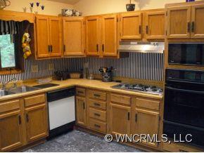 764 Oscar Chappell Road Brevard, NC 28712 - Photo 10 of 21 a kitchen with a sink and cabinets