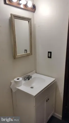 a bathroom with a sink vanity and a mirror