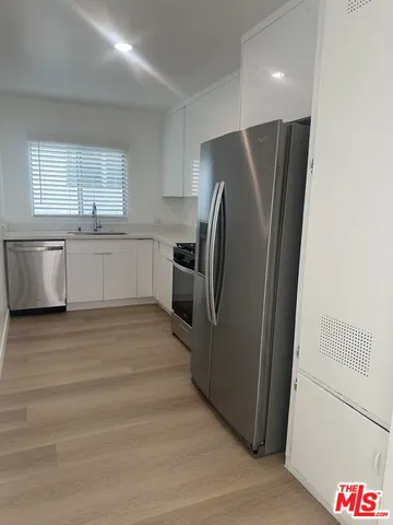 a kitchen with a refrigerator and a sink