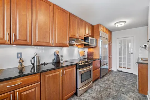 a kitchen with stainless steel appliances granite countertop a stove a sink dishwasher and a refrigerator