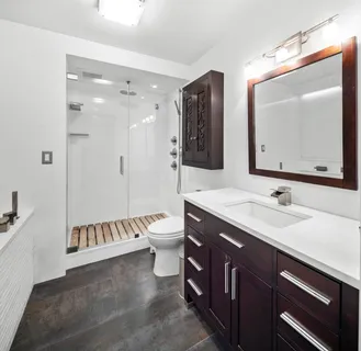 a bathroom with a double vanity sink mirror and bathtub