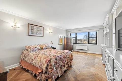 a bedroom with a large bed and a window