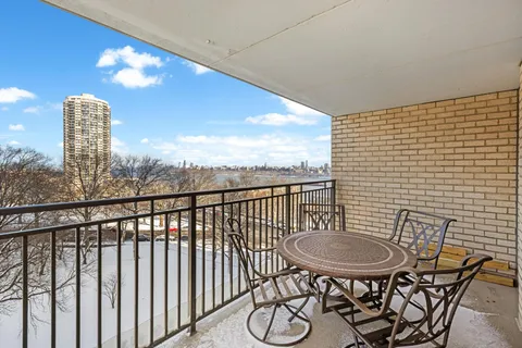 a view of a balcony with table and chairs