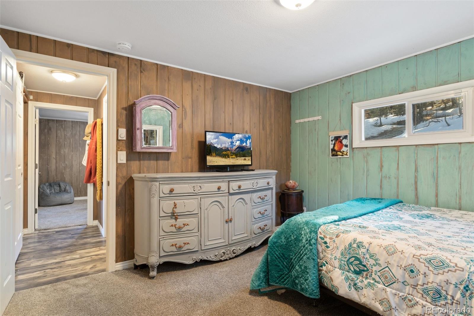 6230 Waterfall Loop Manitou Springs, CO 80829 - Photo 13 of 23 a bedroom with a bed and a television