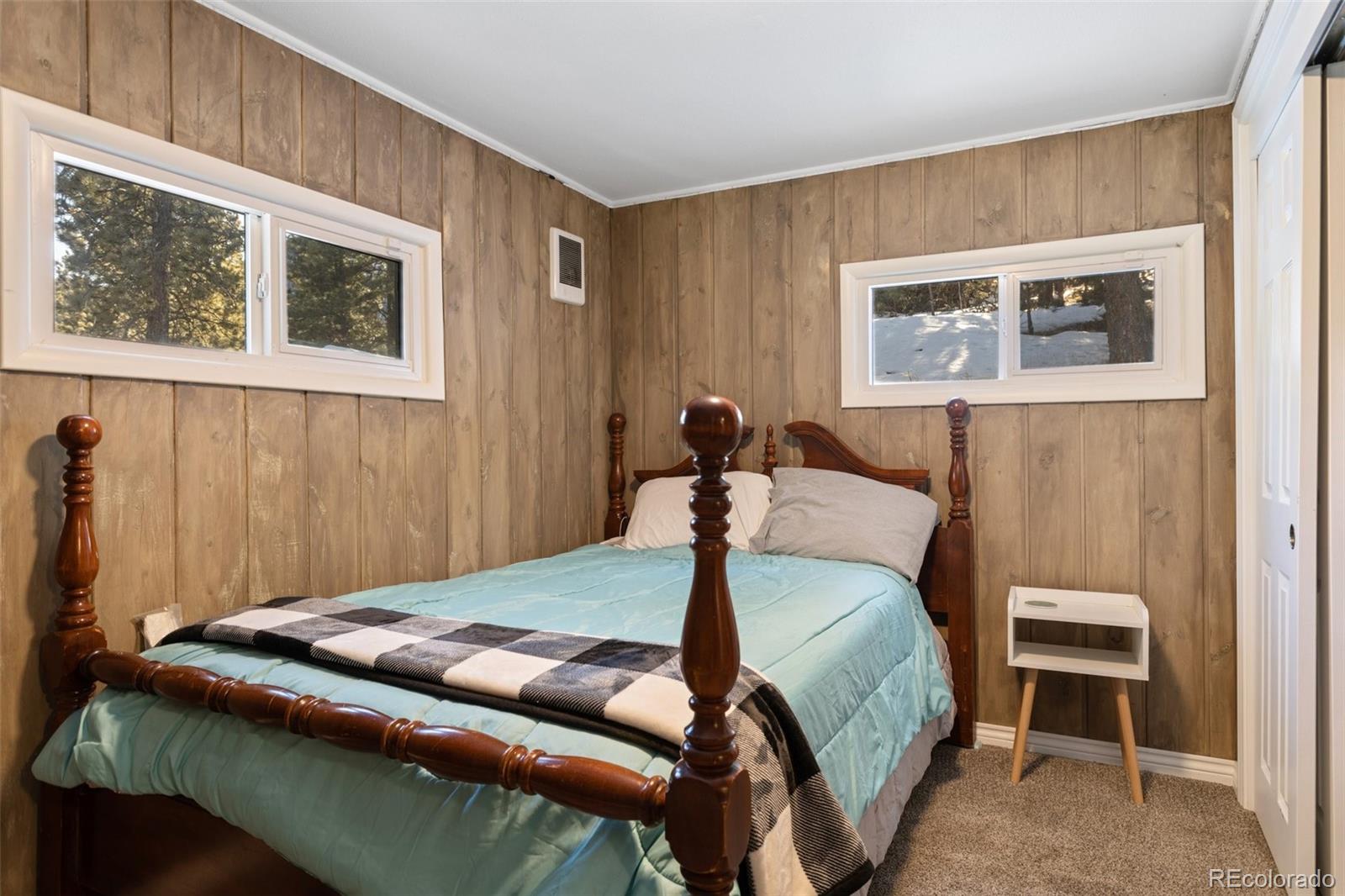 6230 Waterfall Loop Manitou Springs, CO 80829 - Photo 15 of 23 a bedroom with a bed and a painting on the wall