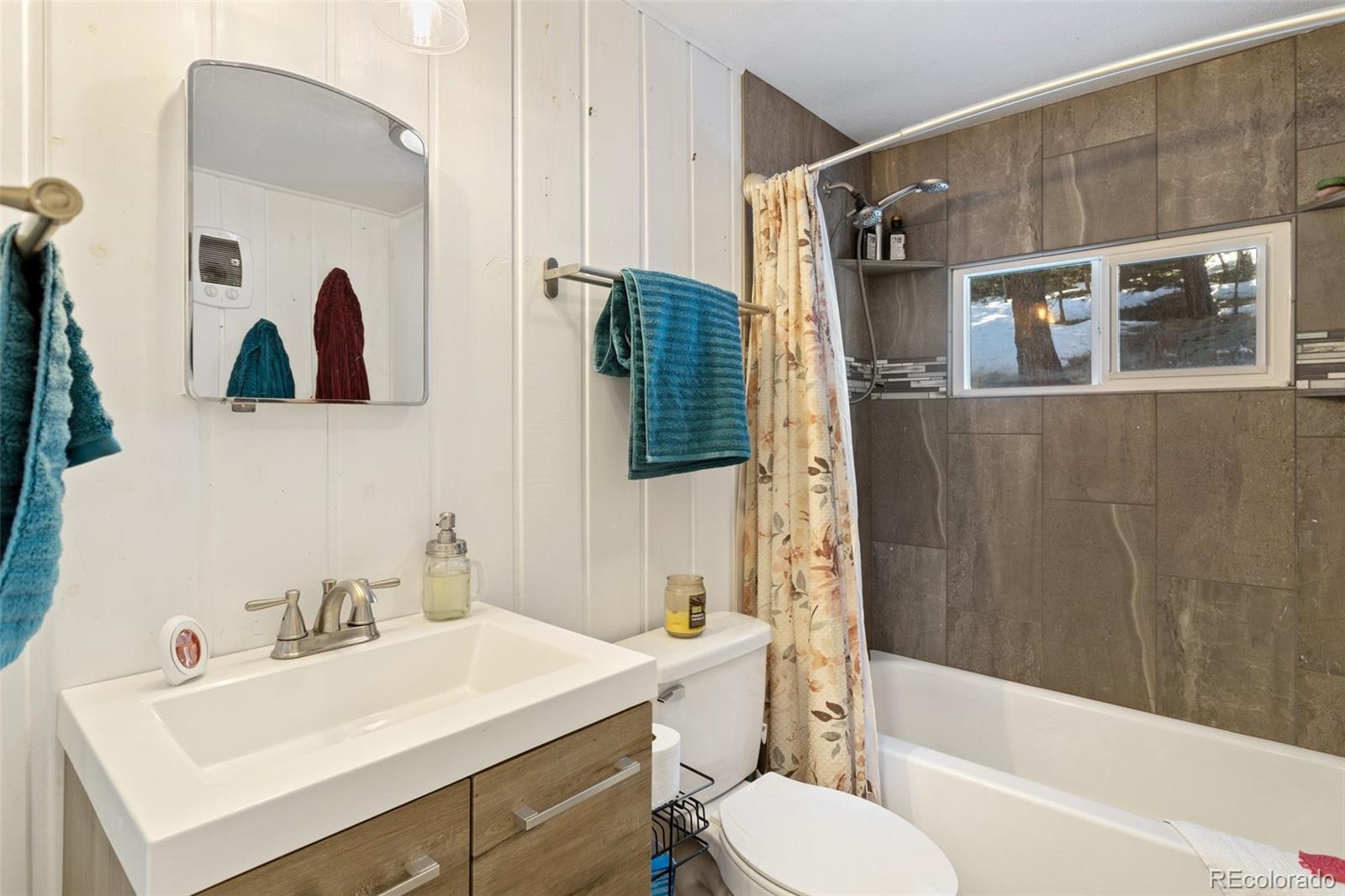 6230 Waterfall Loop Manitou Springs, CO 80829 - Photo 17 of 23 a bathroom with a sink a toilet and shower