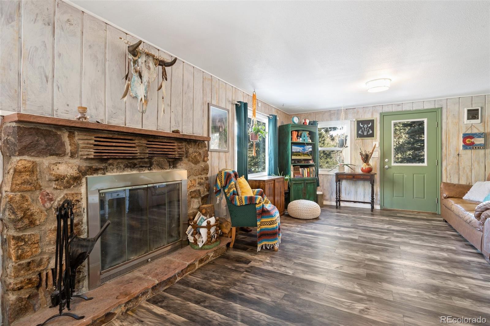 6230 Waterfall Loop Manitou Springs, CO 80829 - Photo 4 of 23 a living room with furniture a fireplace and a window