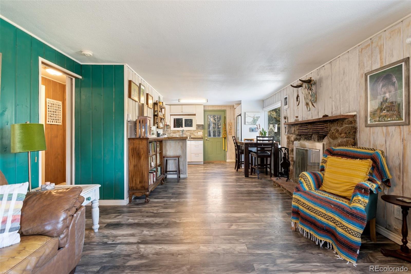 6230 Waterfall Loop Manitou Springs, CO 80829 - Photo 5 of 23 a living room with furniture and wooden floor