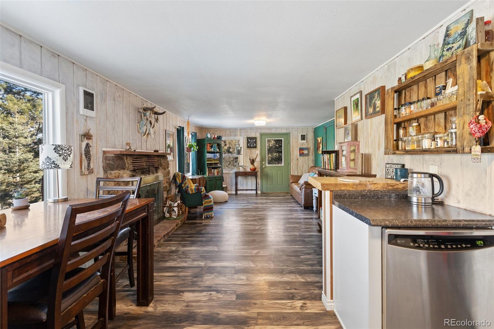 6230 Waterfall Loop Manitou Springs, CO 80829 - Photo 7 of 23 a living room with fireplace furniture and a wooden floor