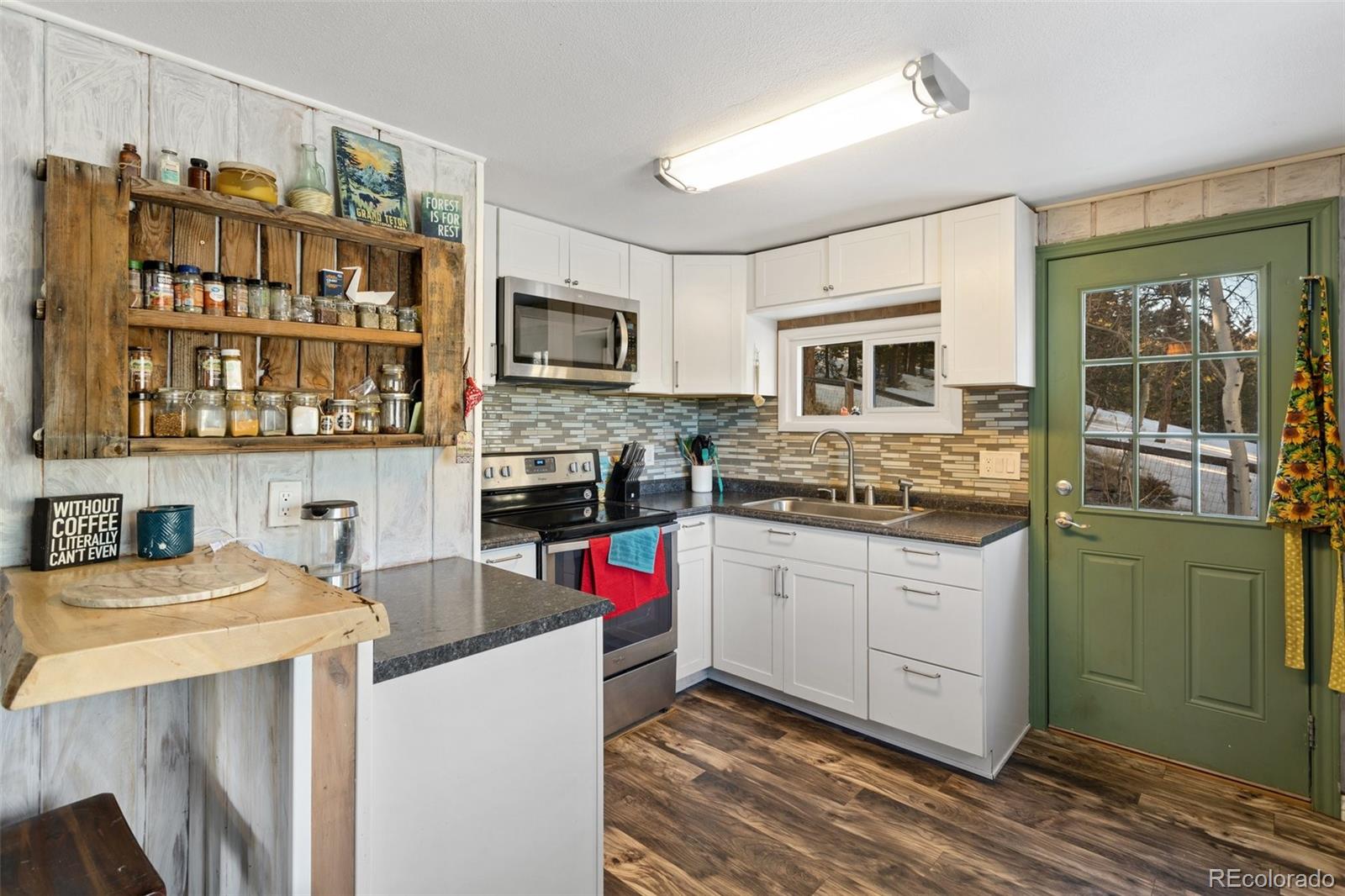 6230 Waterfall Loop Manitou Springs, CO 80829 - Photo 8 of 23 a kitchen with a stove and a microwave