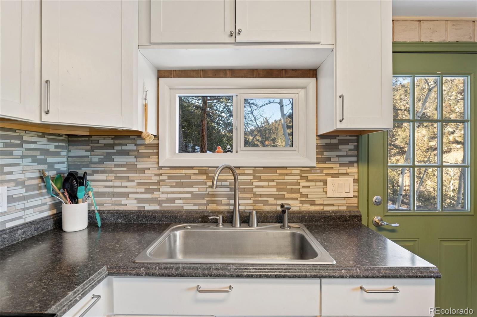 6230 Waterfall Loop Manitou Springs, CO 80829 - Photo 9 of 23 a kitchen with sink a window and potted plant