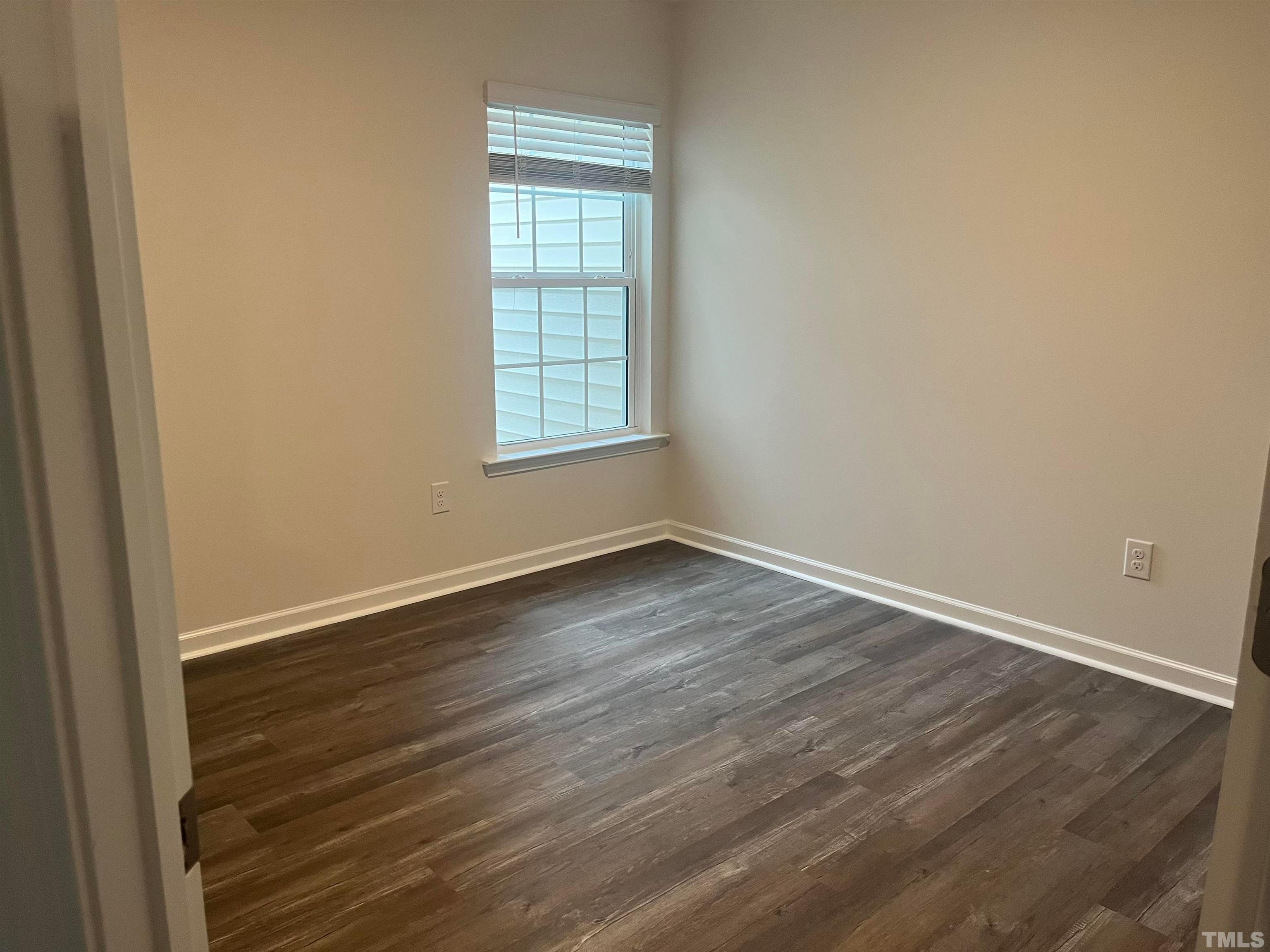 5018 Jayden Drive Durham, NC 27704 - Photo 13 of 22 an empty room with wooden floor and windows