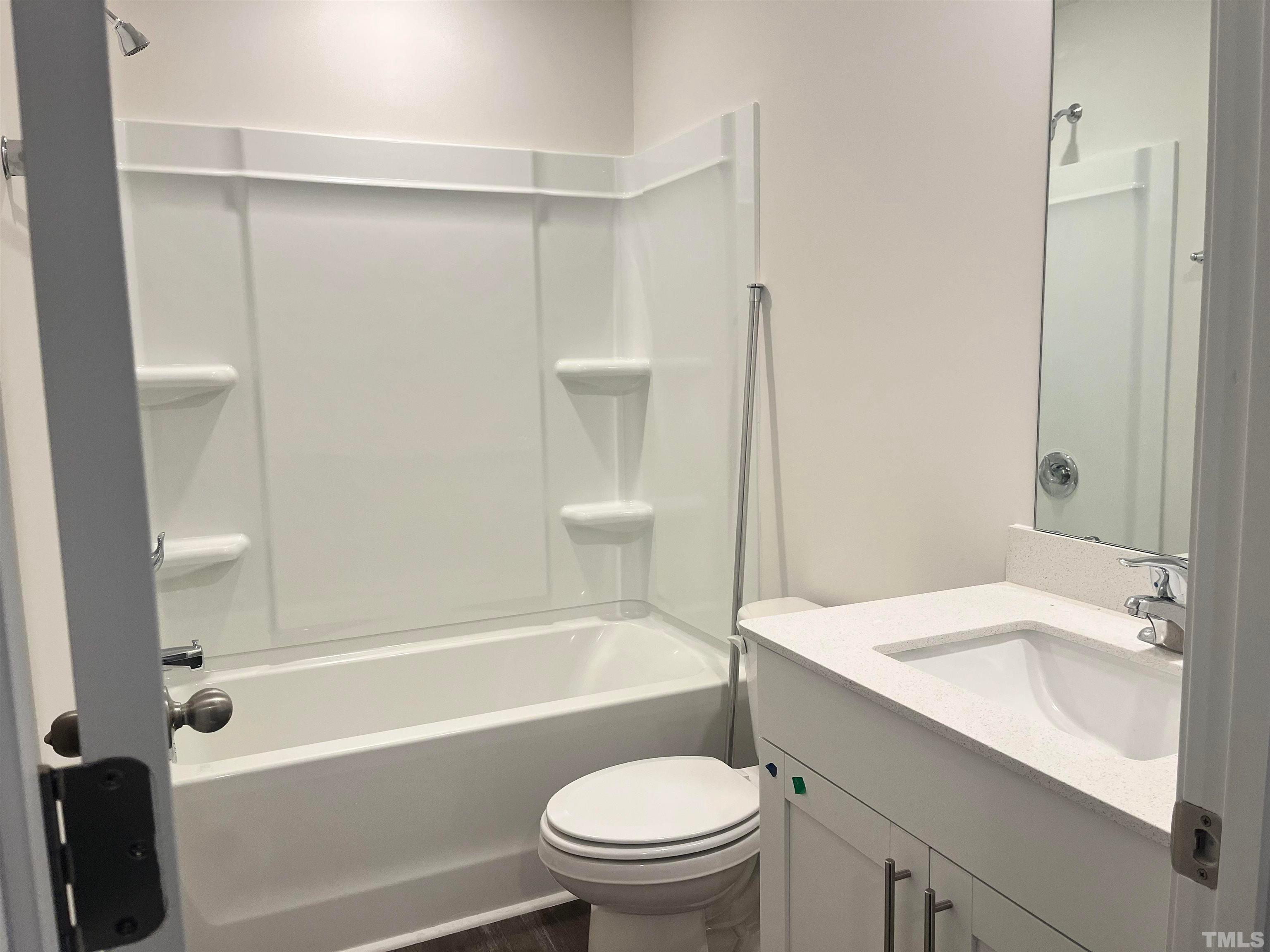 5018 Jayden Drive Durham, NC 27704 - Photo 19 of 22 a bathroom with a sink a toilet and a bathtub