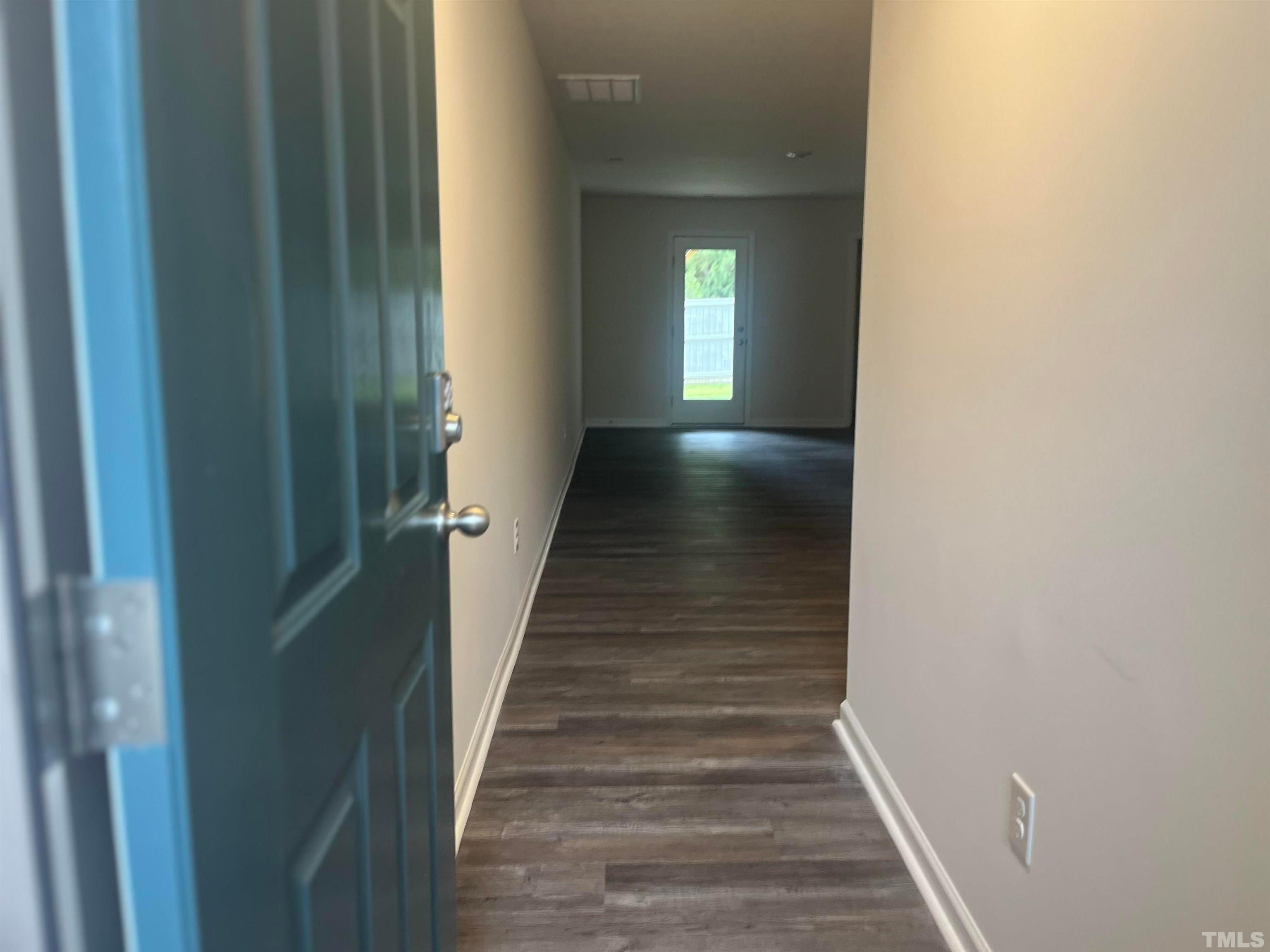 5018 Jayden Drive Durham, NC 27704 - Photo 3 of 22 a view of a hallway with wooden floor and a bathroom