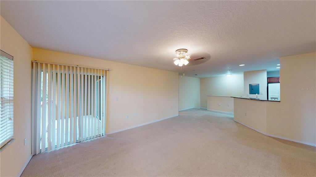 4600 East Moody Boulevard, Unit 5N Bunnell, FL 32110 - Photo 11 of 44 a view of an empty room with a chandelier fan