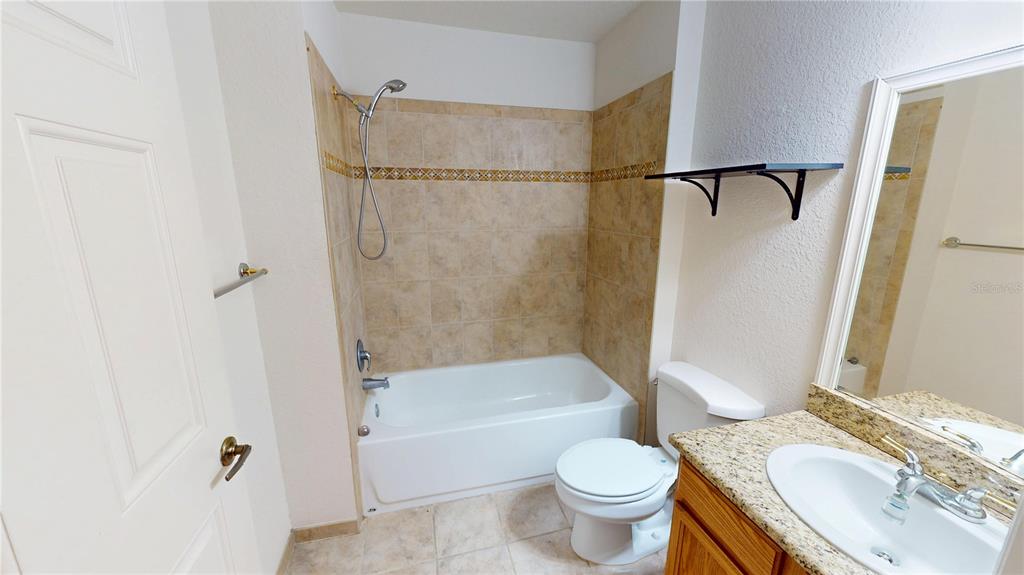 4600 East Moody Boulevard, Unit 5N Bunnell, FL 32110 - Photo 19 of 44 a bathroom with a sink toilet and shower