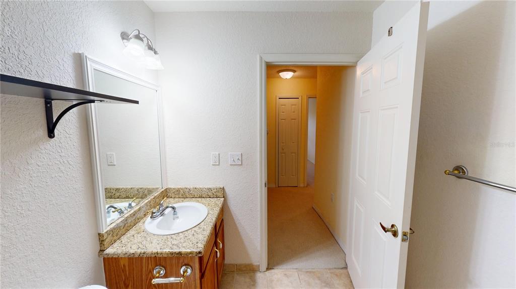 4600 East Moody Boulevard, Unit 5N Bunnell, FL 32110 - Photo 21 of 44 a bathroom with a sink and a mirror
