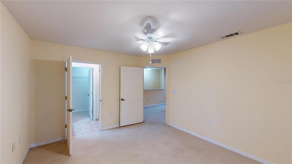 4600 East Moody Boulevard, Unit 5N Bunnell, FL 32110 - Photo 24 of 44 a view of an empty room and chandelier fan