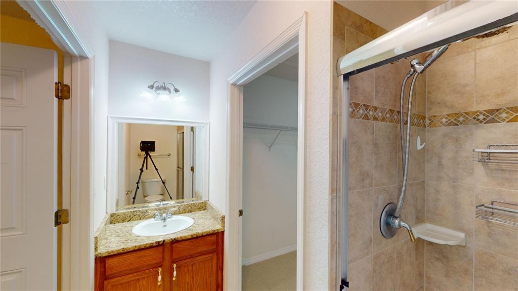 4600 East Moody Boulevard, Unit 5N Bunnell, FL 32110 - Photo 27 of 44 a bathroom with a granite countertop shower sink and mirror