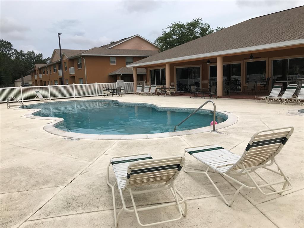 4600 East Moody Boulevard, Unit 5N Bunnell, FL 32110 - Photo 41 of 44 a swimming pool with outdoor seating and yard