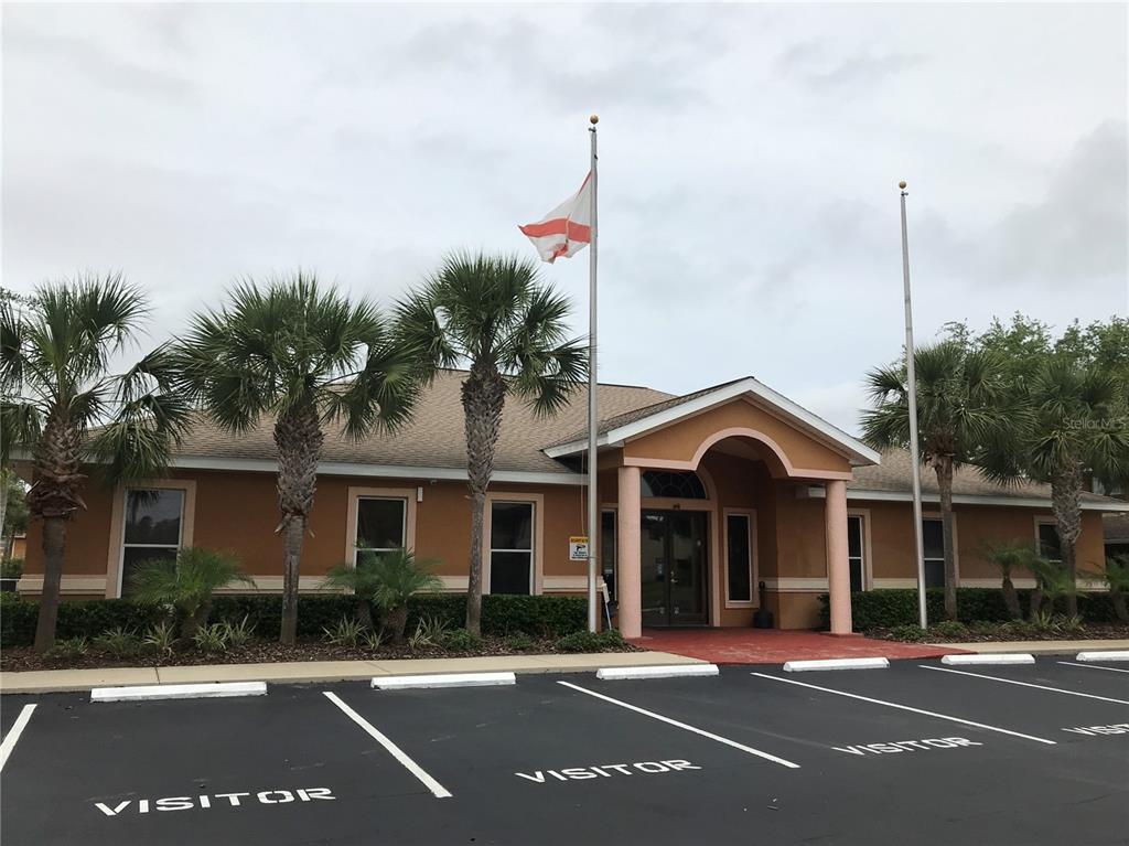 4600 East Moody Boulevard, Unit 5N Bunnell, FL 32110 - Photo 42 of 44 a view of a brick building next to a road with plants