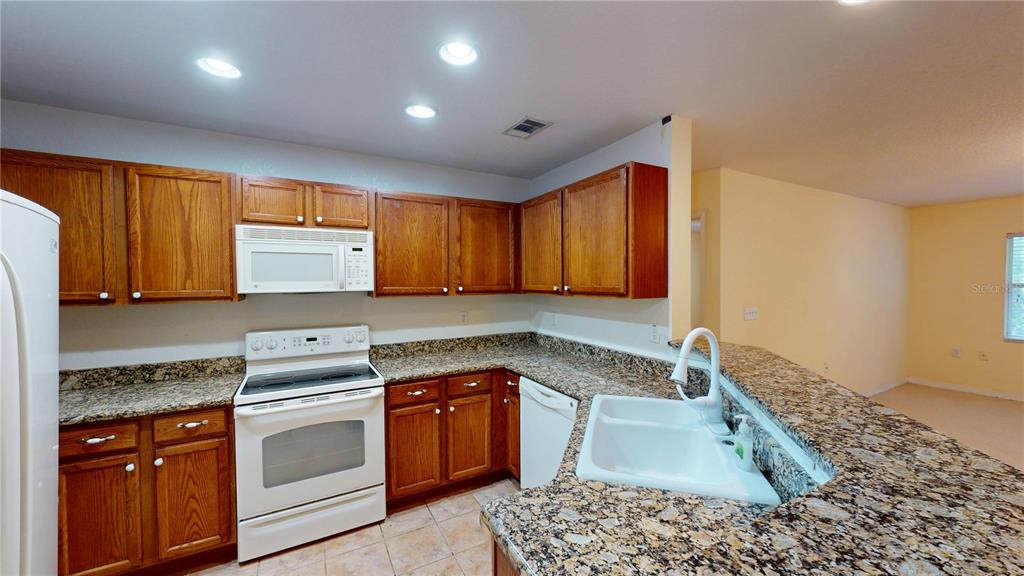 4600 East Moody Boulevard, Unit 5N Bunnell, FL 32110 - Photo 5 of 44 a kitchen with a sink stove and cabinets