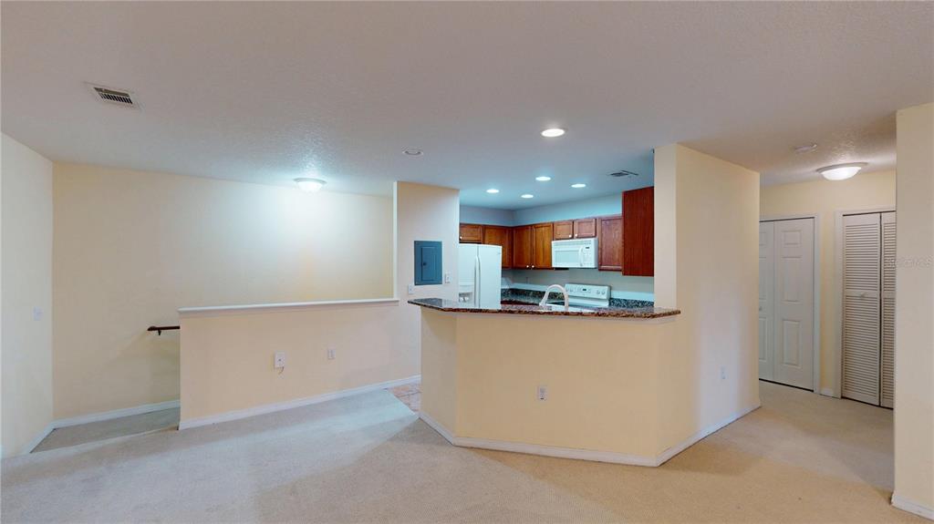 4600 East Moody Boulevard, Unit 5N Bunnell, FL 32110 - Photo 9 of 44 a kitchen with stainless steel appliances a refrigerator and a stove top oven