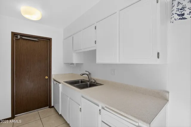 a kitchen with a sink and a refrigerator