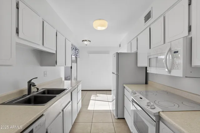 a kitchen with a sink and cabinets