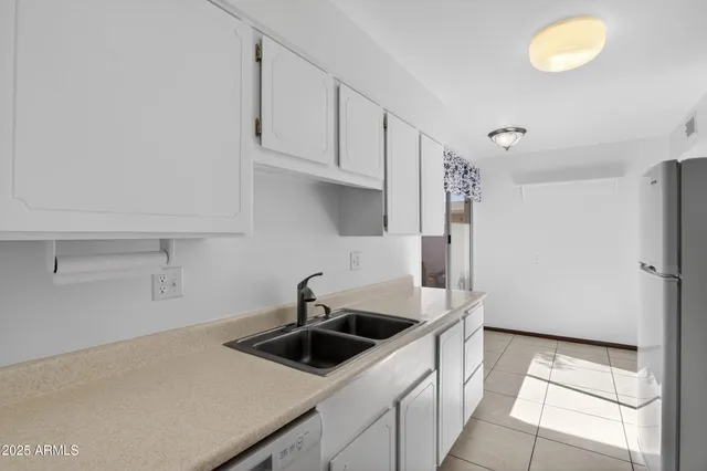 a kitchen that has a sink and a stove