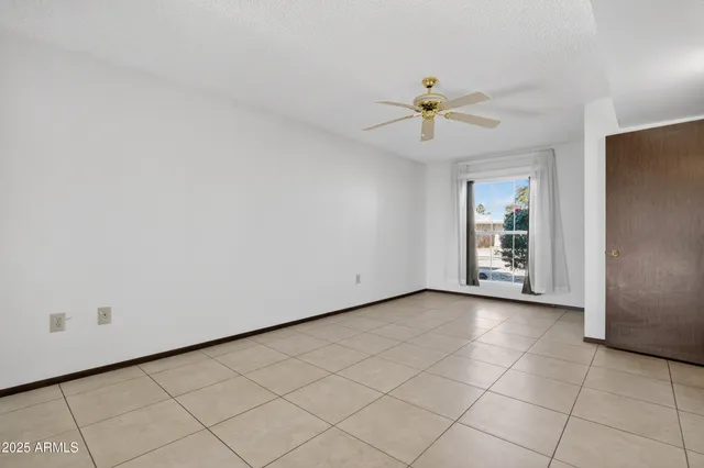 a view of a livingroom with an empty space and a window