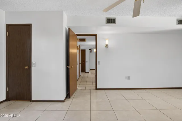 a view of a livingroom with a ceiling fan and entryway