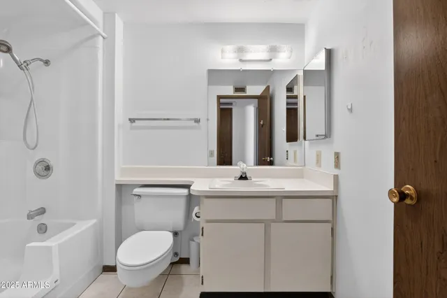a bathroom with a sink toilet tub and shower