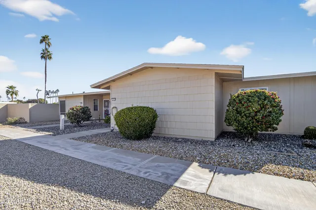a view of a house with a yard and plants