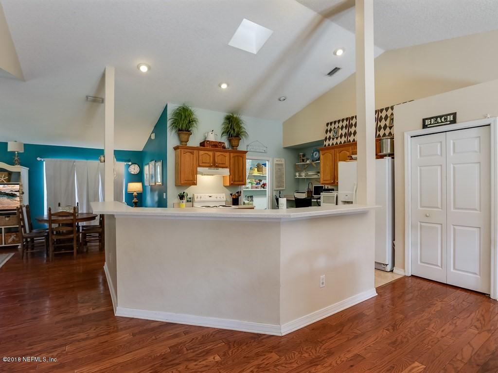 907 Alicante Road St. Augustine, FL 32086 - Photo 6 of 21 an open kitchen with wooden floor and stainless steel appliances