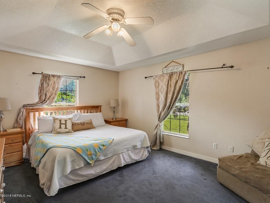 907 Alicante Road St. Augustine, FL 32086 - Photo 8 of 21 a bedroom with a bed and a window