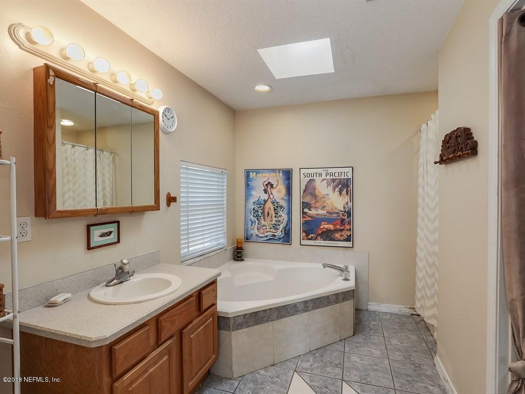 907 Alicante Road St. Augustine, FL 32086 - Photo 9 of 21 a bathroom with a tub sink and mirror