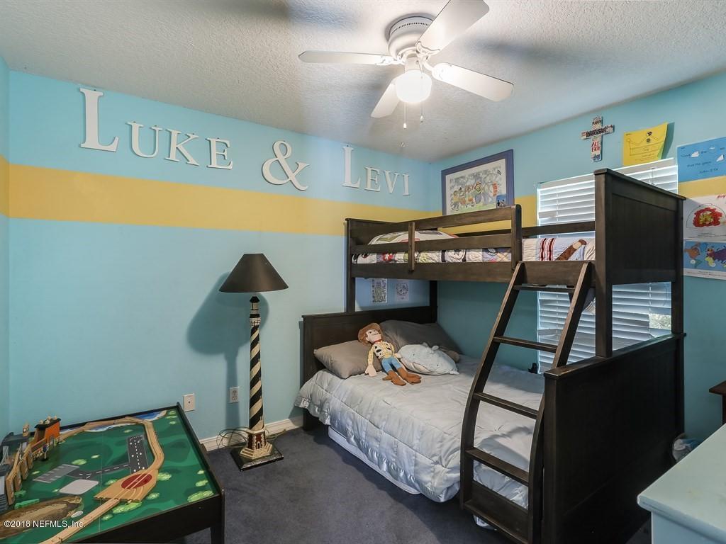 907 Alicante Road St. Augustine, FL 32086 - Photo 10 of 21 a bedroom with a bed and wooden floor