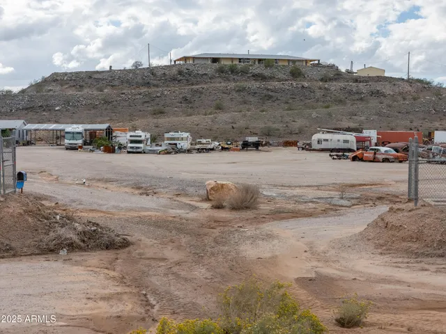 a view of a swimming pool with lawn chairs under an umbrella