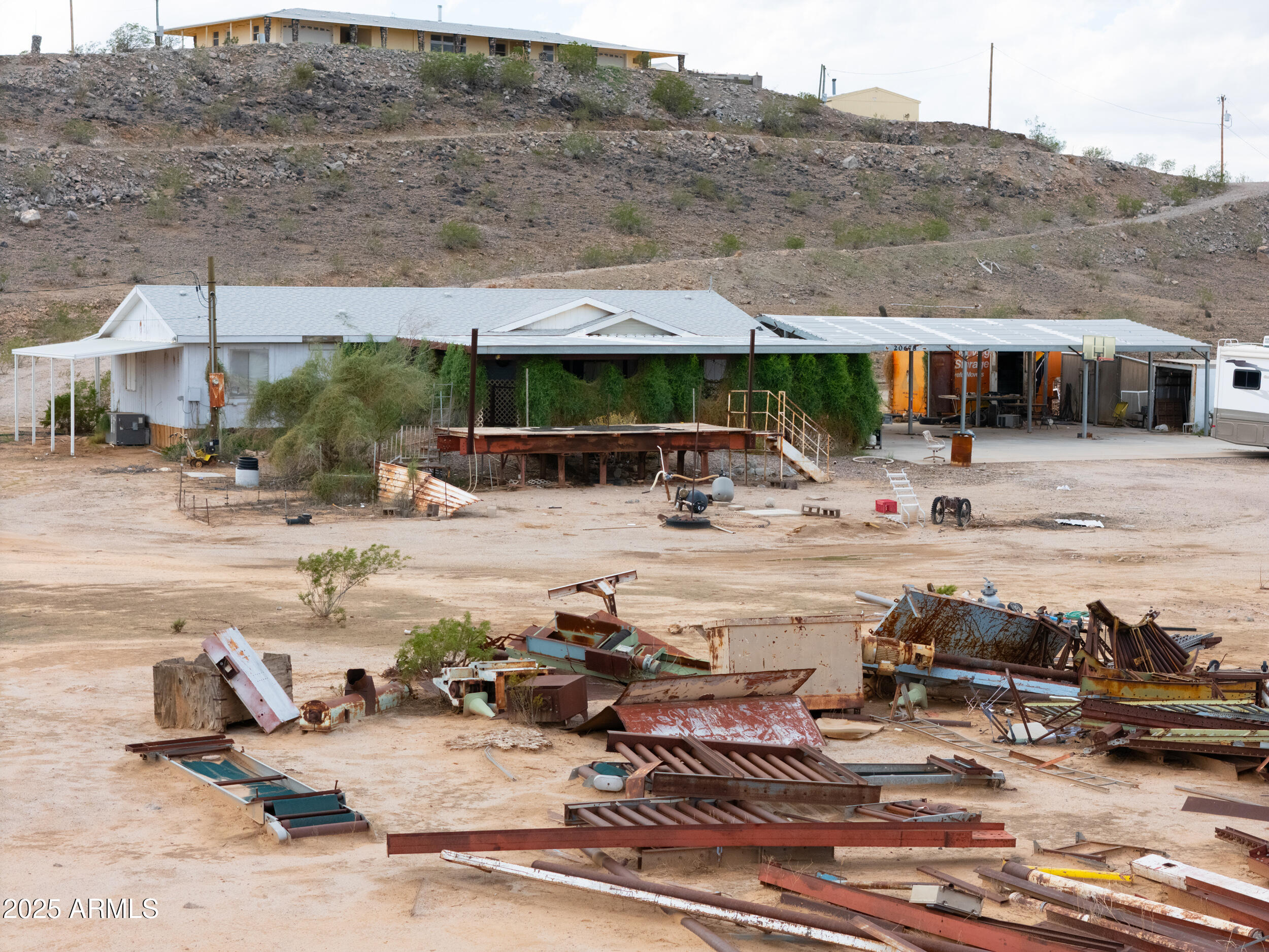 20678 North Warren Road Maricopa, AZ 85139 - Photo 24 of 31 a view of a swimming pool with lawn chairs under an umbrella