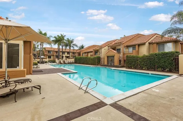 a view of a house with swimming pool and sitting area
