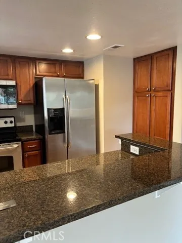 a kitchen with kitchen island a counter top space appliances and cabinets