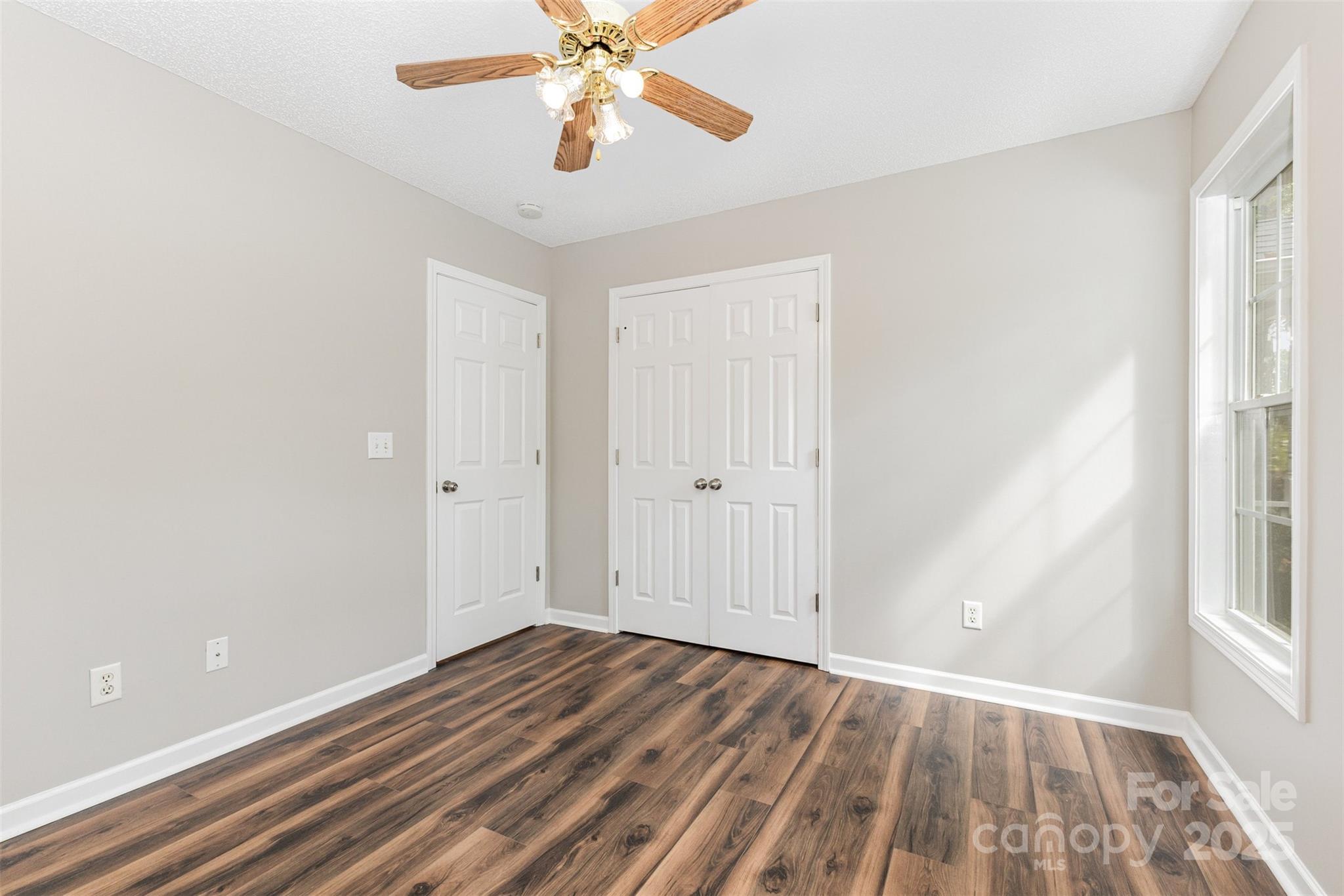 159 Scotch Pine Drive York, SC 29745 - Photo 16 of 28 wooden floor in an empty room with a window