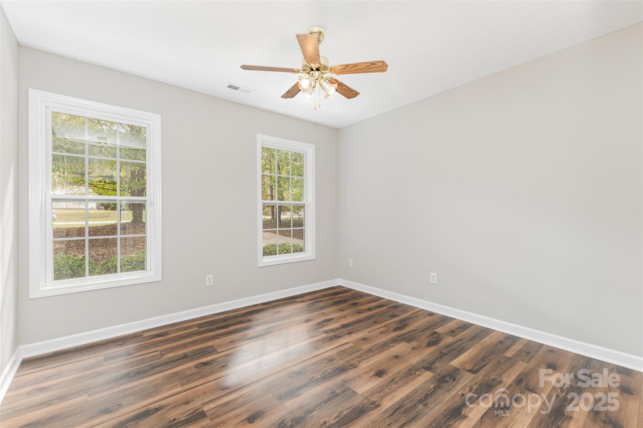 159 Scotch Pine Drive York, SC 29745 - Photo 17 of 28 an empty room with wooden floor fan and windows