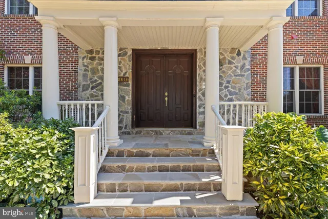 a view of hallway with stairs and wooden floor